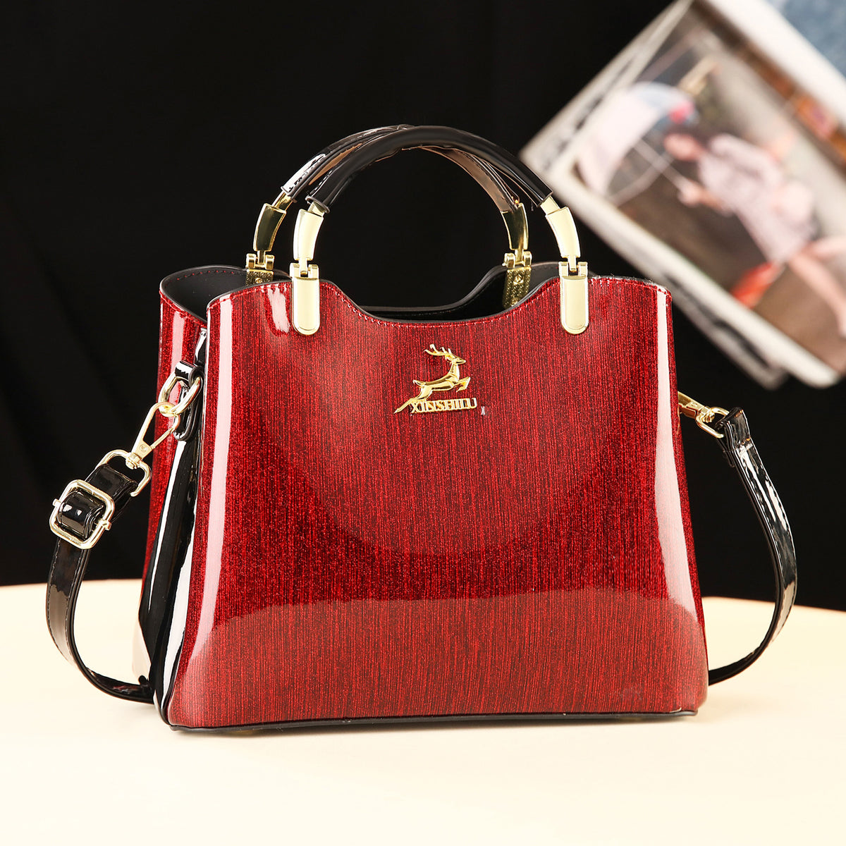 Red handbag with gold accents and a visible brand logo on a light background
